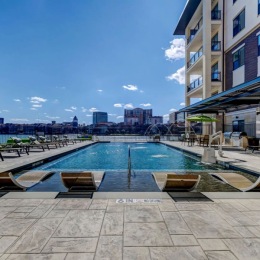 resort style pool with seating and a building beside it