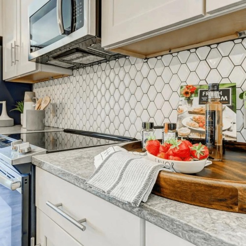 a kitchen with a table and a bowl of fruit